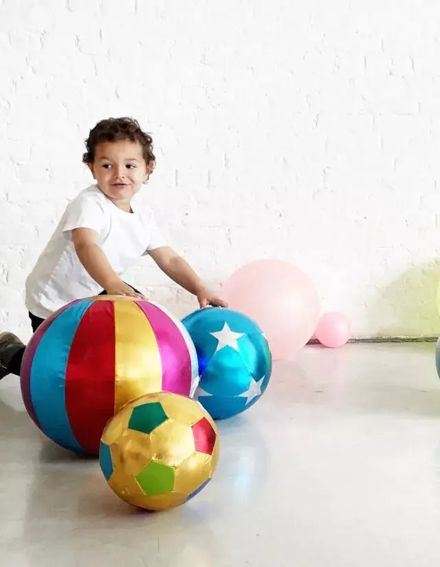 Happy child playing with colorful Ratatam! circus balls in vibrant colors, perfect for indoor fun and playtime.